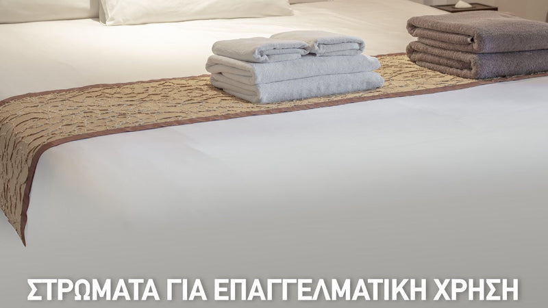 Στρώμα ξενοδοχείου με πετσέτες διπλωμένες για επαγγελματική χρήση