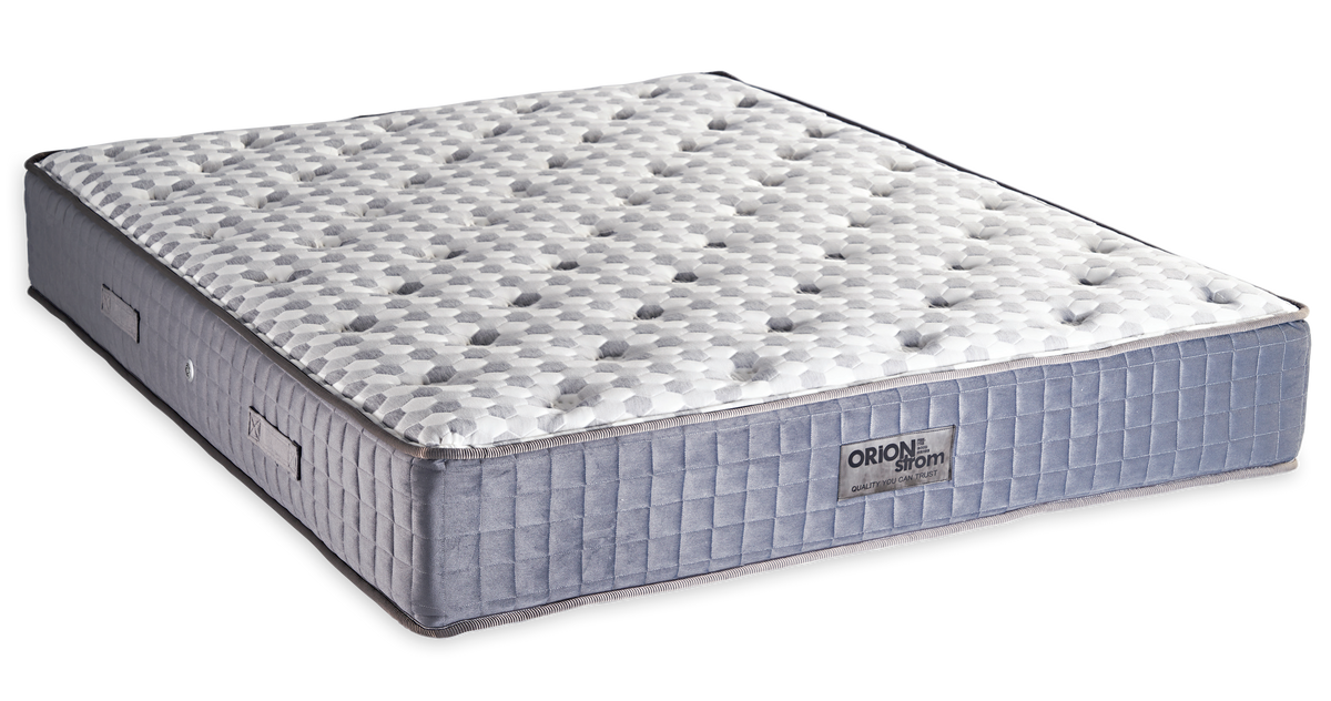 764 Filoxenia Mundial Cotton Latex Afrolatex — Angled view: white textured quilting and a grey fabric border with vertical stitching. Feel: medium-firm. Orthopaedic mattress.