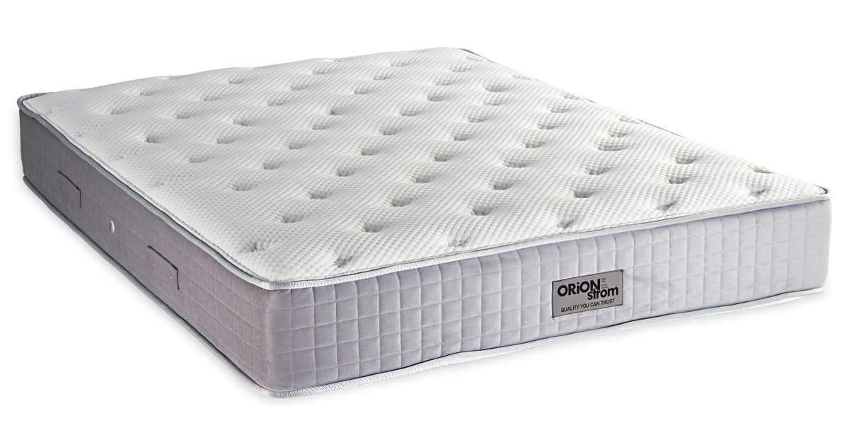 849 Filoxenia Platinum Cotton Latex Wool Afrolatex Coco Orion Zone Pocket — Angled view: white textured quilting and a grey fabric border with vertical stitching. Feel: medium-firm. Anatomical mattress.